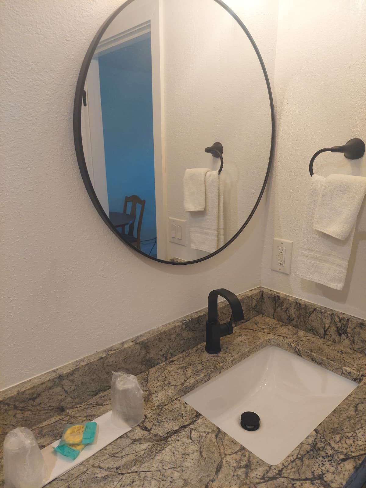 Granite vanity with round mirror